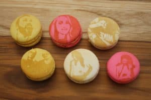 Five macarons featuring a woman's image, ideal for corporate events with entertainment flair.