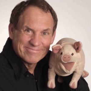 Taylor Mason holding a stuffed pig.
