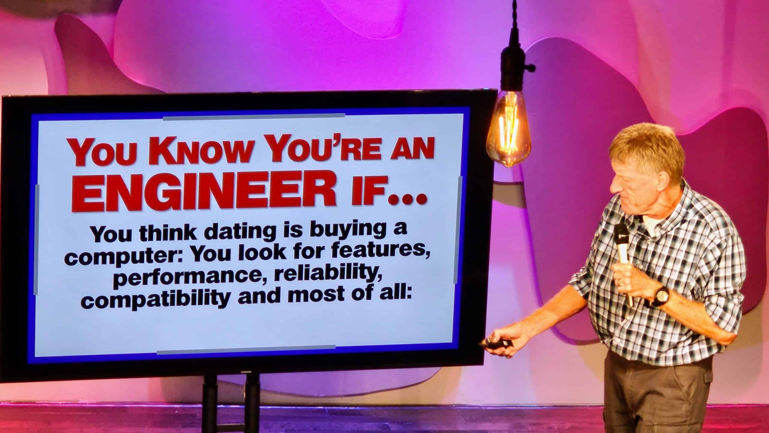 Don McMillan presenting a humorous slide about dating from an engineer’s perspective, highlighting his unique tech-inspired comedy style.
